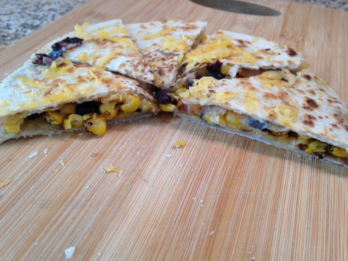 An easy snack or Lunch for one: Meatless Quesadilla.  Sharp Cheddar Cheese, Black Beans, Trader Joe's Fire Roasted Corn all in a Flour Tortillas, BUEN
