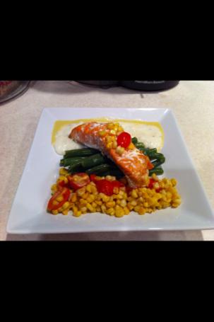 Cheese grits, corn, a sweet corn sauce and grilled salmon