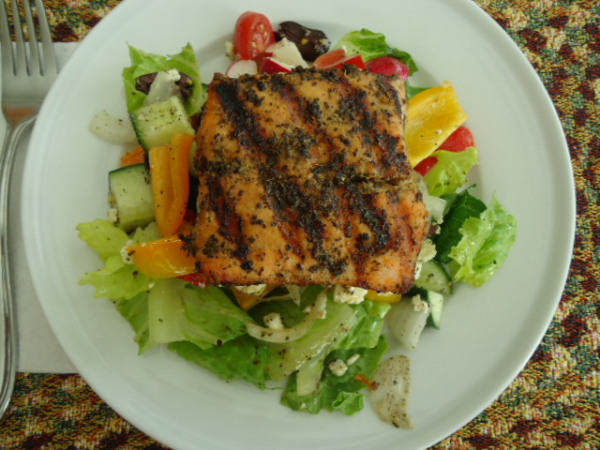 Greek-Inspired Salad topped with Grilled Salmon