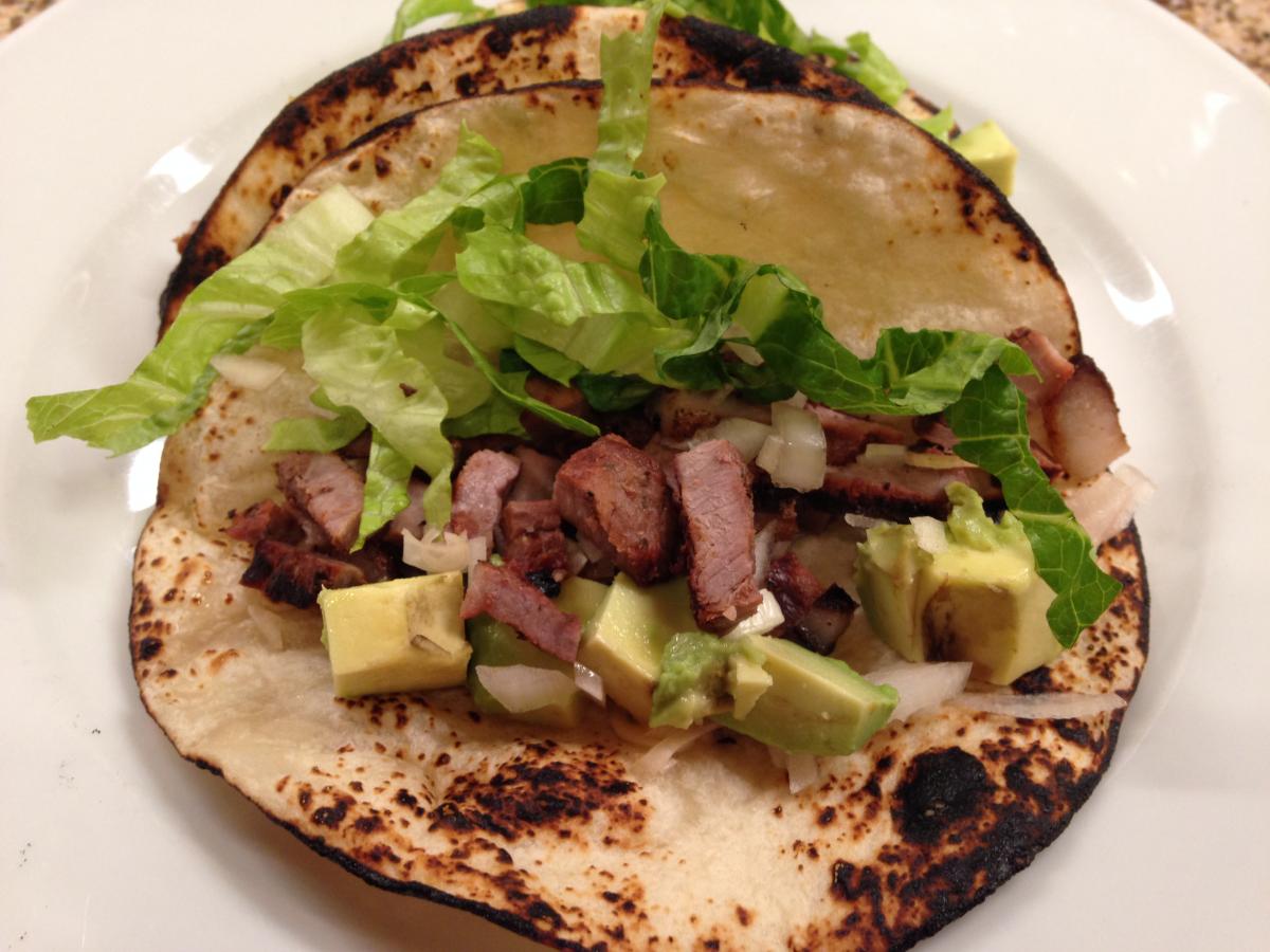 Grilled Carne Asada Taco with fire toasted Flour Tirtillas filled with Steak and diced Avocado