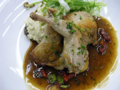 Seared quails on risotto with herb demi