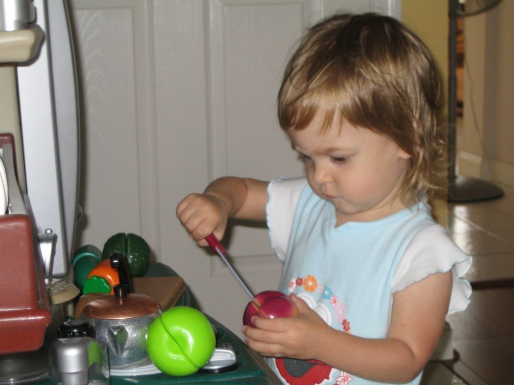 Sofie loves playing in the kitchen, mine or hers.  Most creations involve "cutting", and she loves to talk to herself while she cooks, saying "chef's 