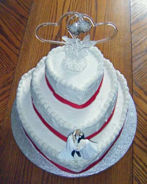 The three heart tiers were lined up at the back to that we could fit both the family heirloom topper and the one the bride bought.